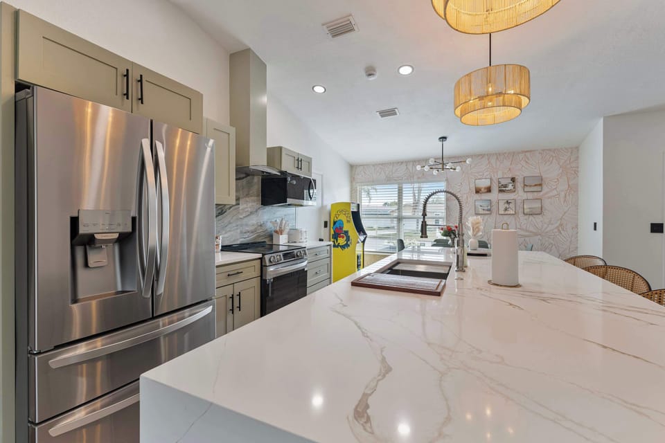 A panoramic view captures the seamless flow between the dining area and kitchen. The inviting layout includes a cozy seating arrangement in the background and a beautifully lit space that encourages family gatherings and culinary adventures alike.