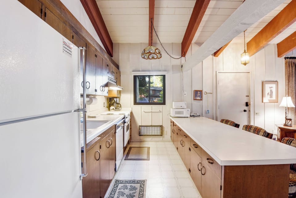 Kitchen with drip coffee pot, toaster, slow cooker, blender, wine ware and more