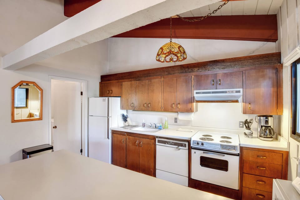Kitchen with drip coffee pot, toaster, slow cooker, blender, wine ware and more