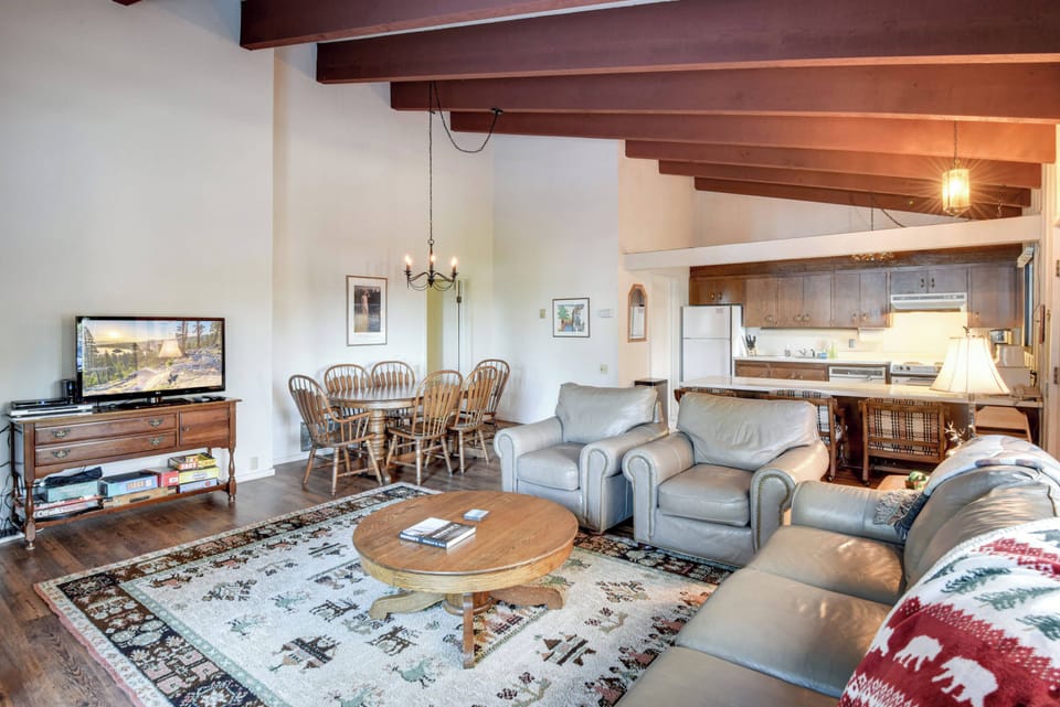 Main living area with dining table, kitchen and living room