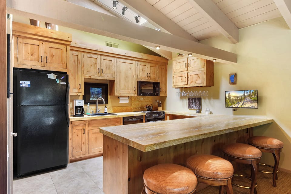 Kitchen with drip coffee pot, slow cooker, dishwasher, and utensils for cooking!