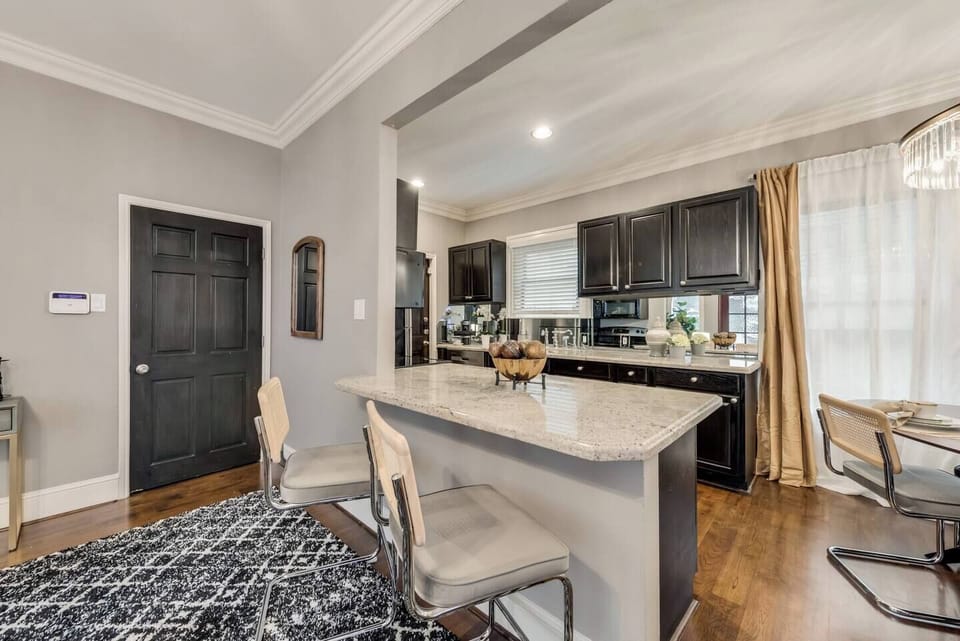 Enjoy counter seating in a spacious, bright living room that seamlessly flows into the open-plan kitchen, creating an inviting and airy atmosphere.