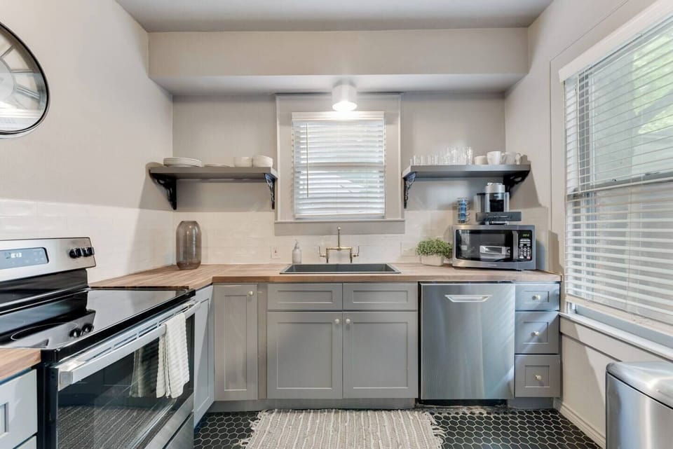 The kitchen is fully equipped with all the essentials and modern appliances, making it perfect for preparing meals with ease and convenience.