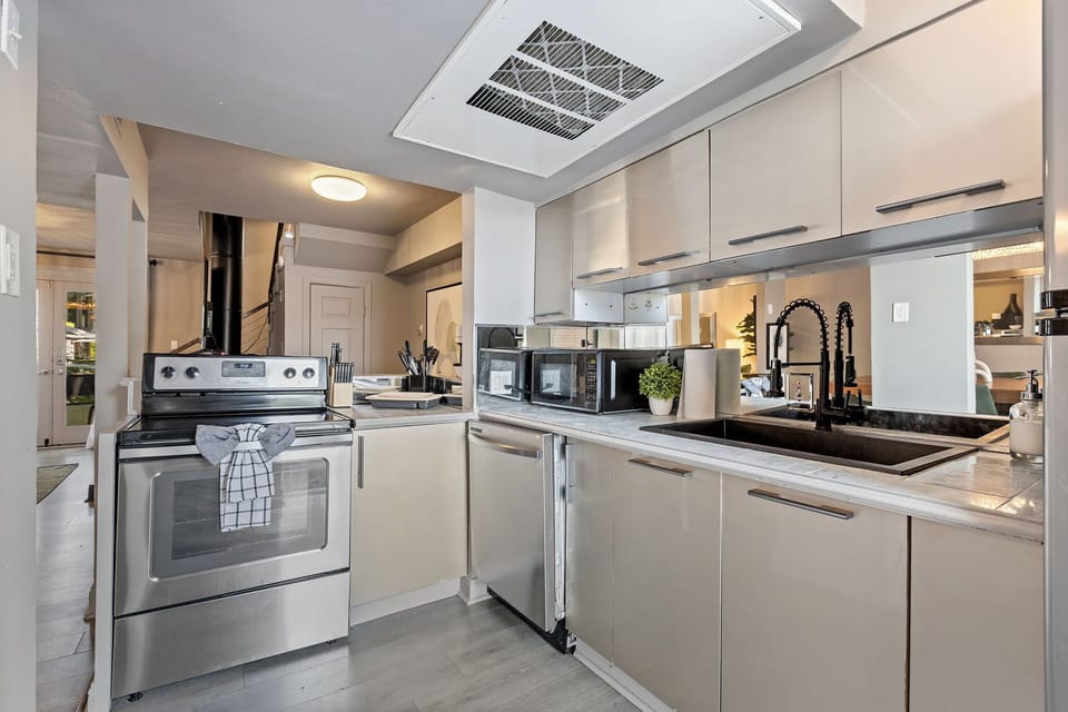 Spacious kitchen with sleek, modern appliances, fully equipped for all your cooking and dining needs.