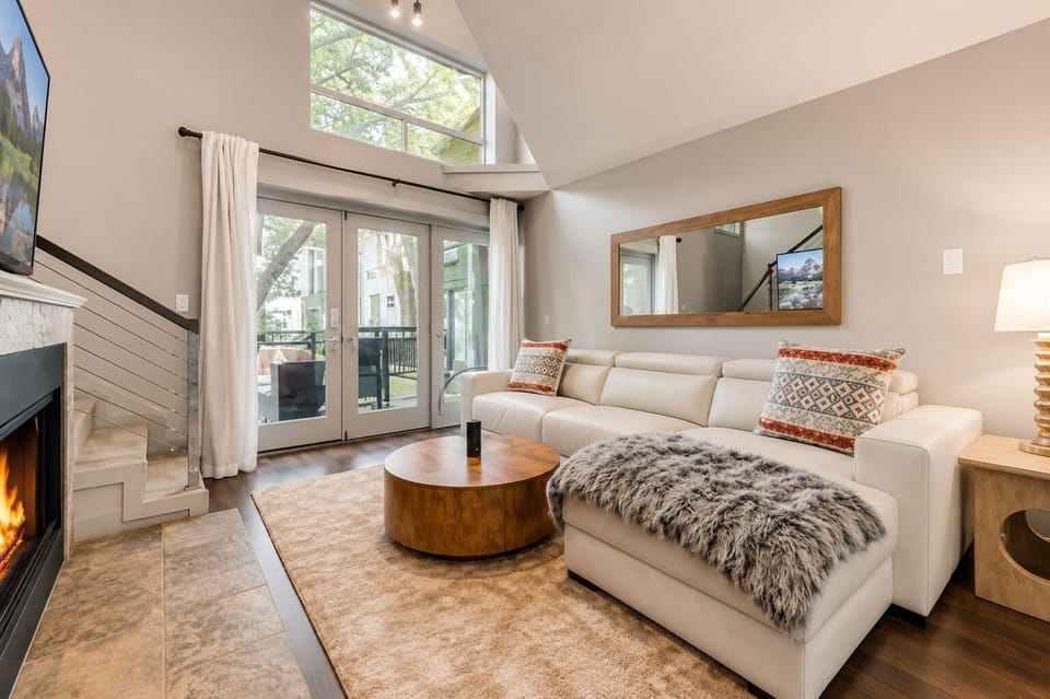 From the living room, enjoy a clear view of the stairs leading to the loft space, complemented by a cozy fireplace and a large smart TV, creating a perfect blend of comfort and style.