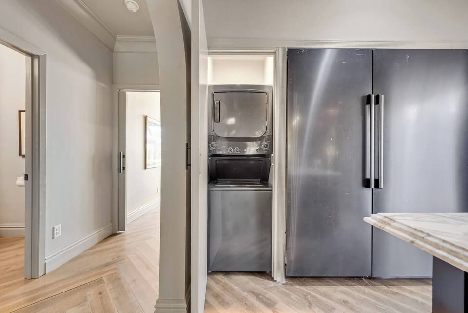 The kitchen features a stackable washer and dryer, making it easy to take care of laundry without ever leaving the comfort of this beautiful space.