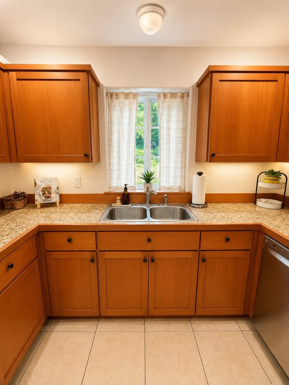 Bright kitchen prep area with double sink, granite counters, and natural light