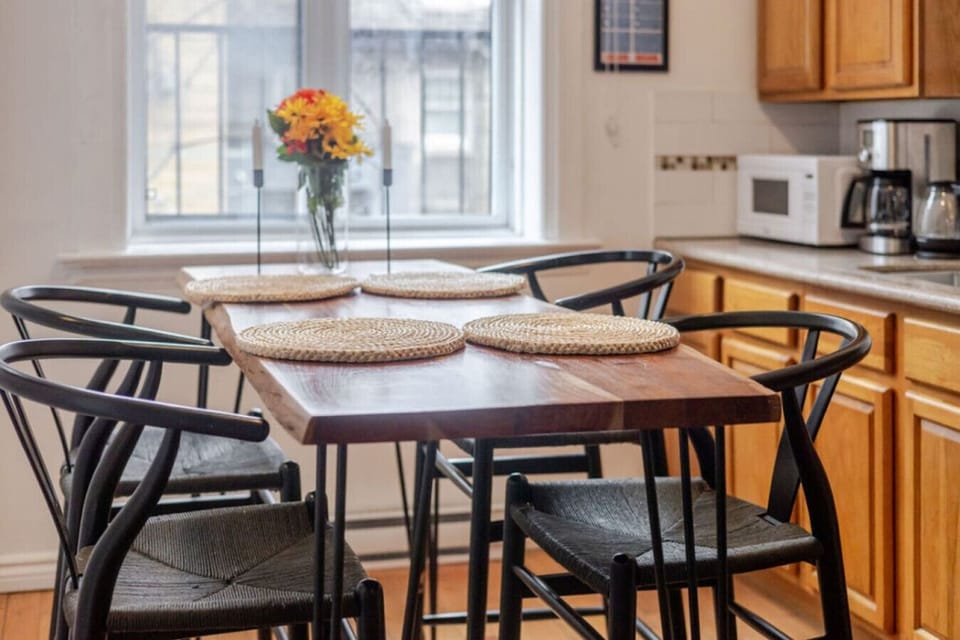 Dining area: Sunlit table set for four, ideal for casual meals or morning coffee