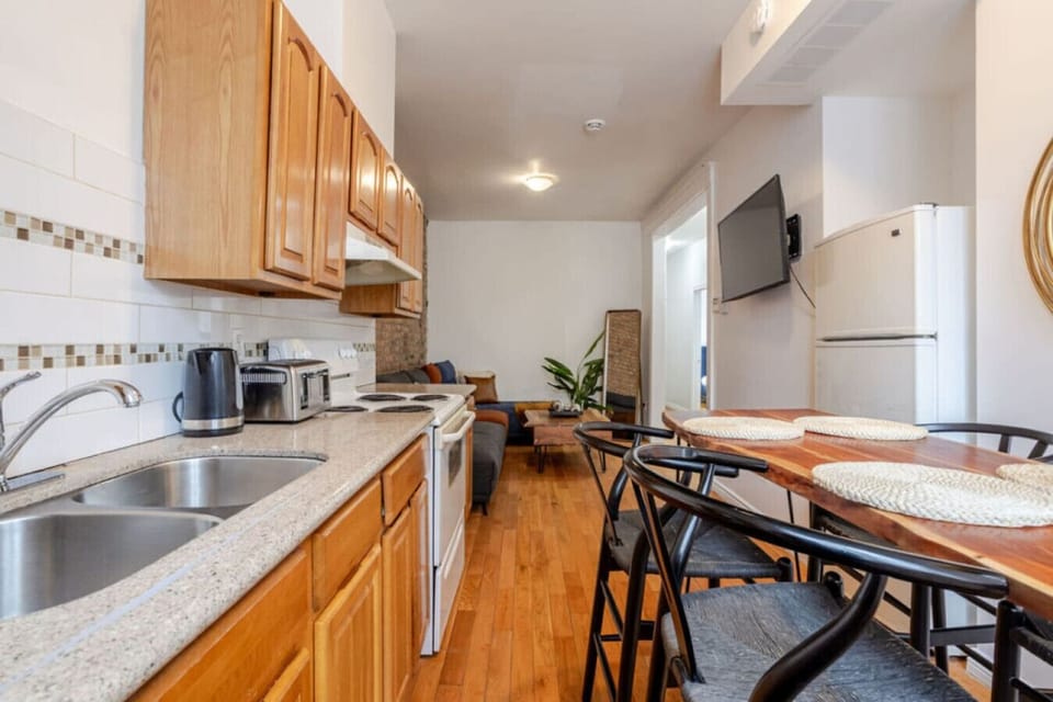 Kitchen: Spacious and well-stocked with wood cabinetry, full-size appliances, and seating for 4