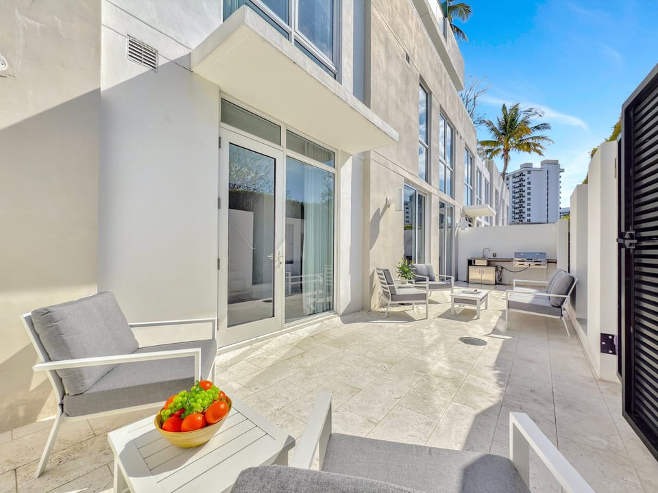 Private Main Entrance | Welcome to Tiffany Tides. Enjoy multiple lounge areas, outdoor kitchen + blue skies.
