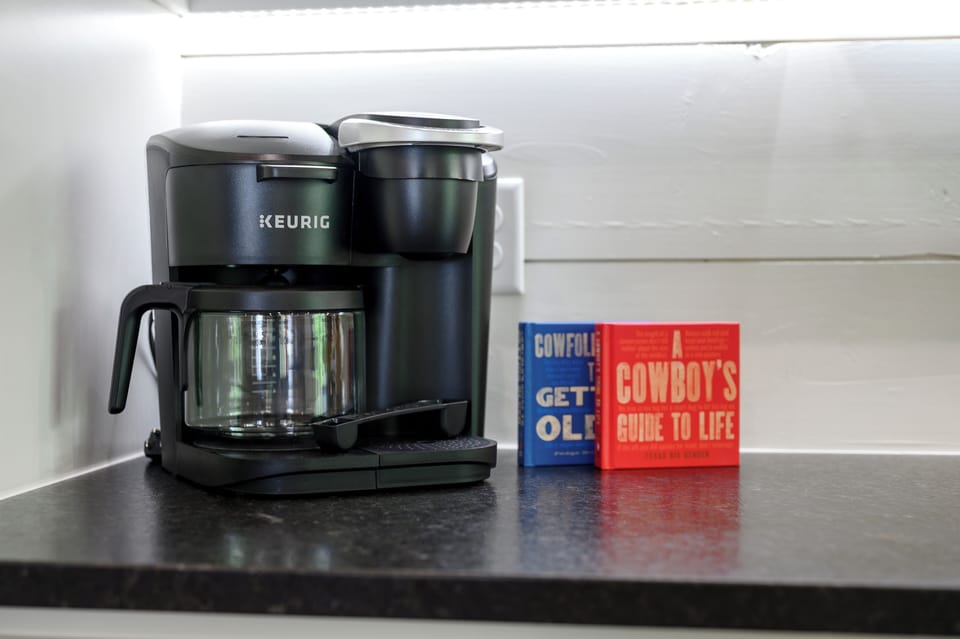 Cozy coffee station with a Keurig and rustic books for a perfect morning vibe.