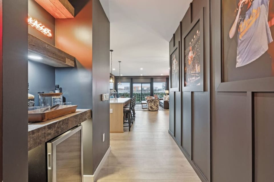 MW hallway with music-themed décor and a convenient bar nook—complete with a mini fridge and extra space for drinks, snacks, and pregame essentials.