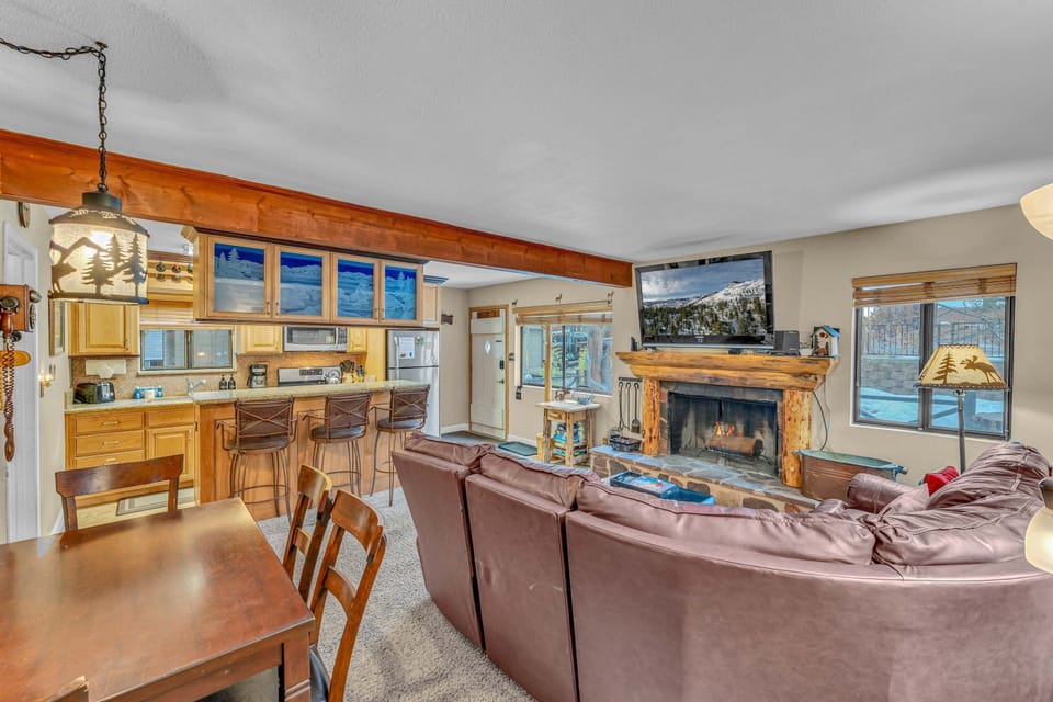 Living Room: Main floor, wood-burning fireplace, Apple TV, sectional seating