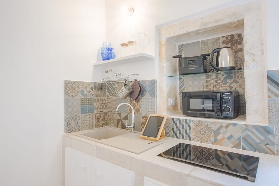 Flooring, Interior Design, Floor, Tile, Countertop, Kitchen, Mosaic, Ceramic, Light Fixture, Major Appliance