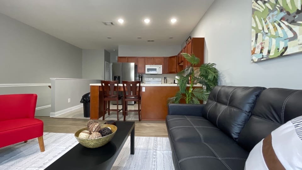 Comfy couch, Smart TV, and a seamless flow to the kitchen—your perfect home-away-from-home setup!