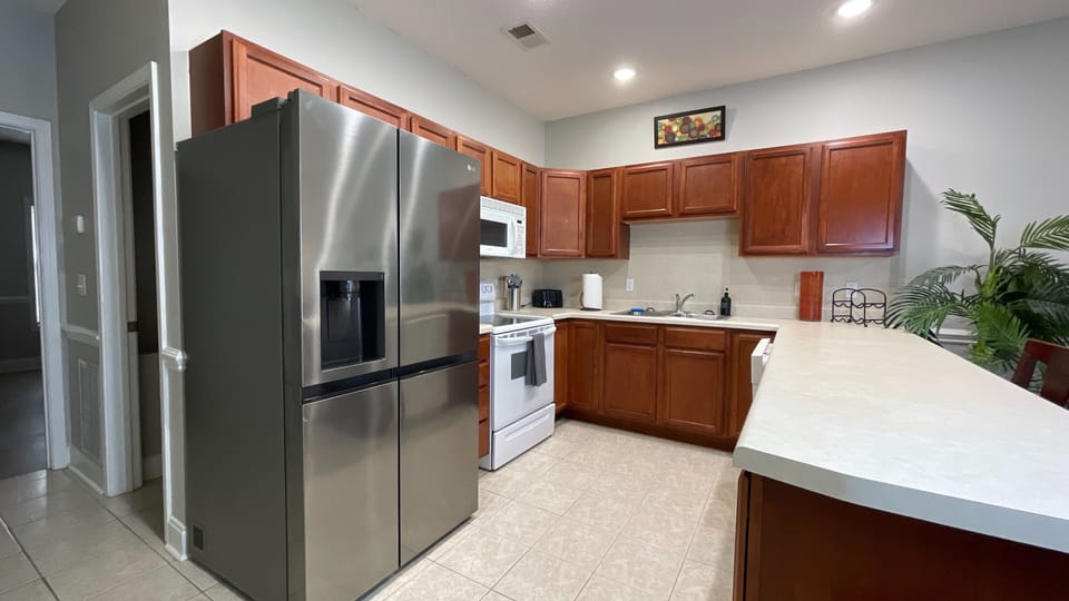 Cook in style with our modern kitchen, featuring a sleek double-door refrigerator and everything you need!