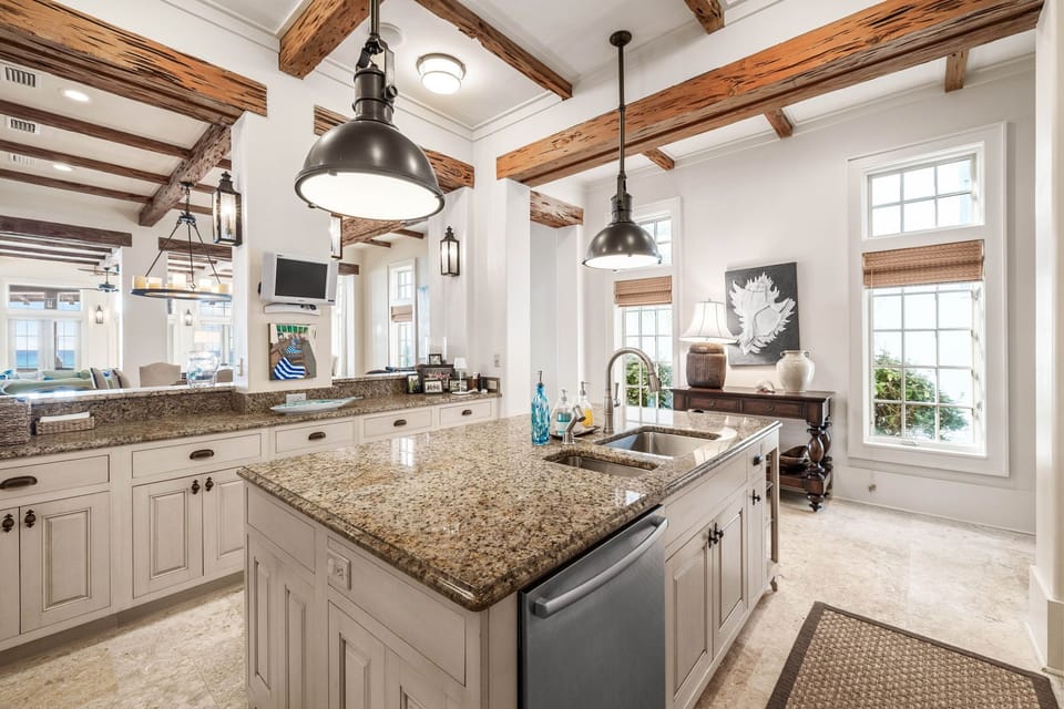 You'll love preparing meals in this stunning chef's kitchen with exposed beams, granite countertops, and gleaming appliances.