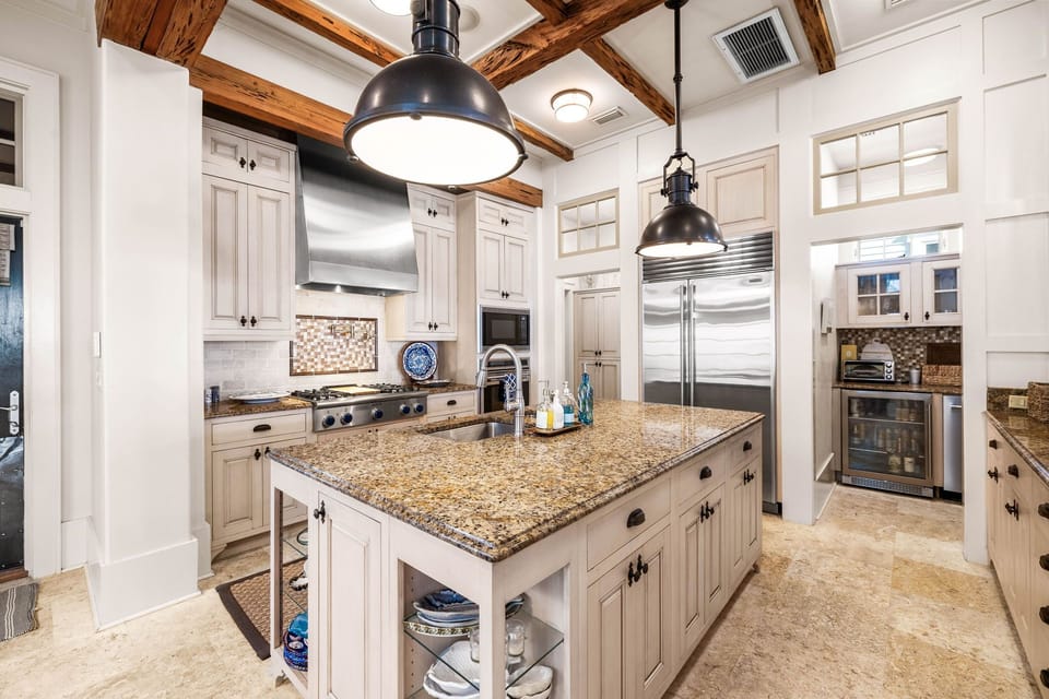 Step into your gourmet kitchen where rustic beams meet modern luxury, featuring granite counters and chef-grade appliances for unforgettable meals.