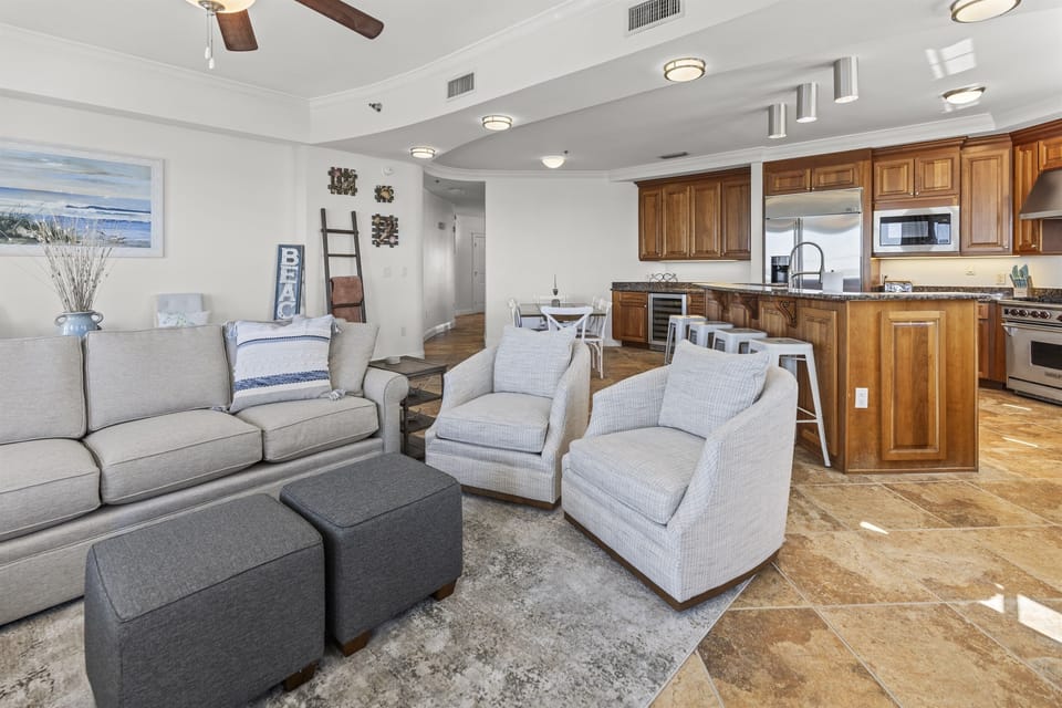 Relax in your spacious living area with plush seating and stunning water views, then prepare meals in your fully equipped gourmet kitchen.