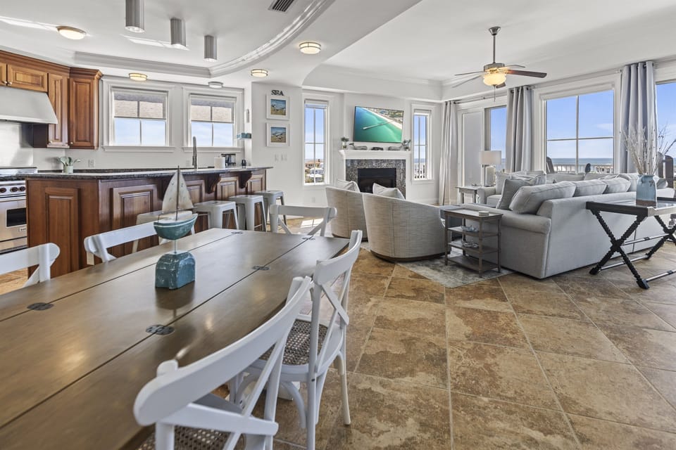Your spacious open-concept retreat flows seamlessly from kitchen to living area, where ocean views fill every window and create the perfect backdrop for relaxation.