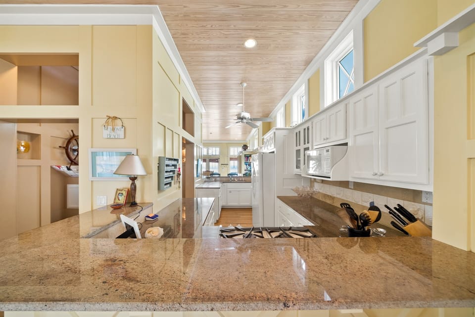 Your spacious gourmet kitchen features granite countertops, premium appliances, and an open layout perfect for cooking memorable vacation meals together.