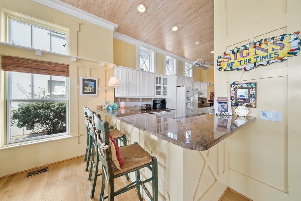 Gather around your spacious granite island for morning coffee and shared meals in this bright, fully-equipped kitchen.