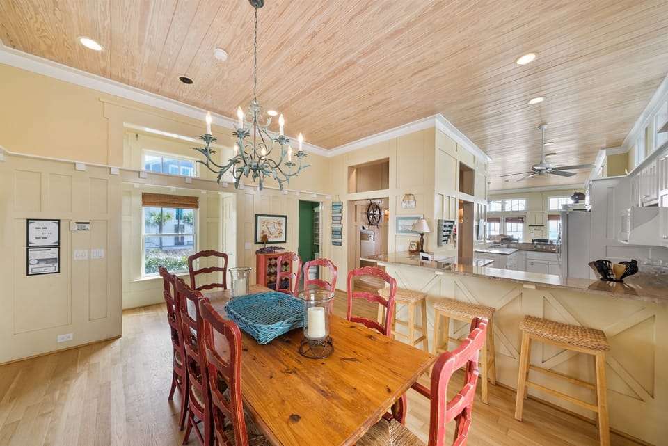 Gather around this farmhouse dining table where your group can share meals under warm pendant lighting and beautiful wood ceilings.