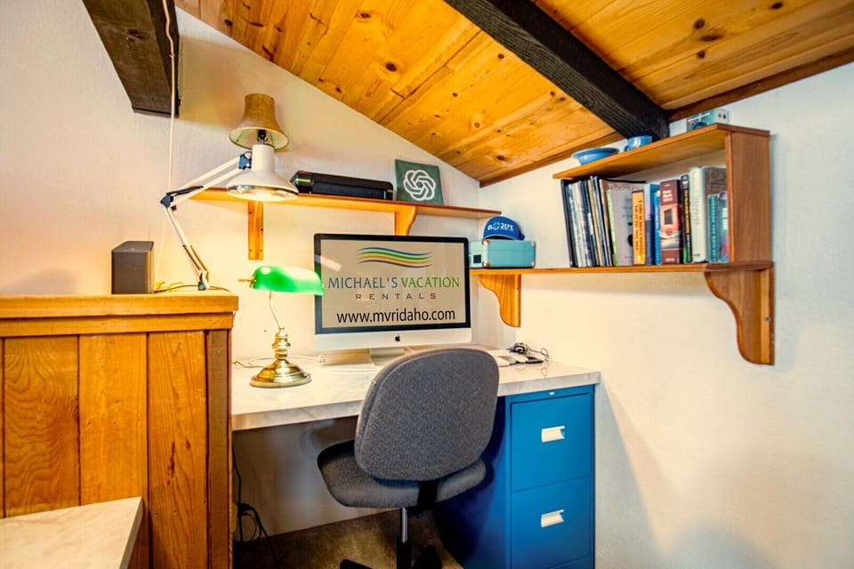 Remote workspace in loft room with Apple computer accessible for guests