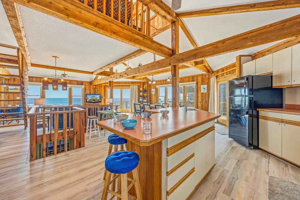 Your spacious kitchen island becomes the heart of gathering, with stunning ocean views framing memorable meals and conversations.