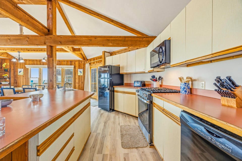 Discover your culinary haven with exposed timber beams overhead and modern appliances at your fingertips for memorable meal preparation.