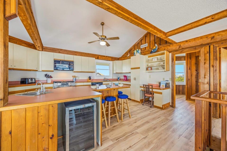 Your rustic kitchen features exposed beam ceilings, modern appliances, and a breakfast bar where you'll love your morning coffee.