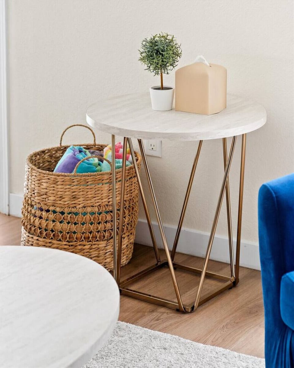 A cute round table and a basket to keep your things organize.