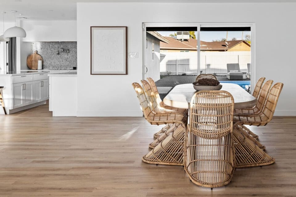 Light-filled dining area with woven chairs and an inviting open layout.