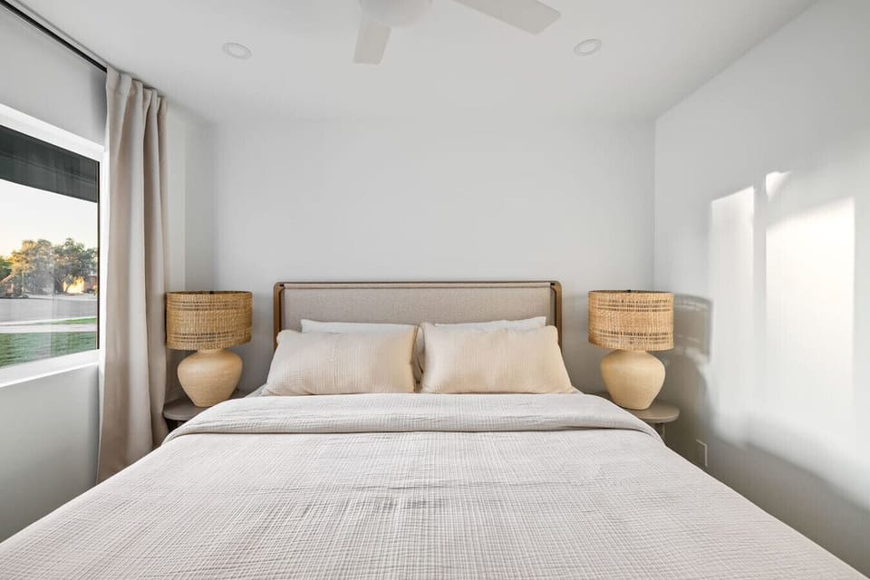 Calm and inviting bedroom with matching lamps and plush pillows.