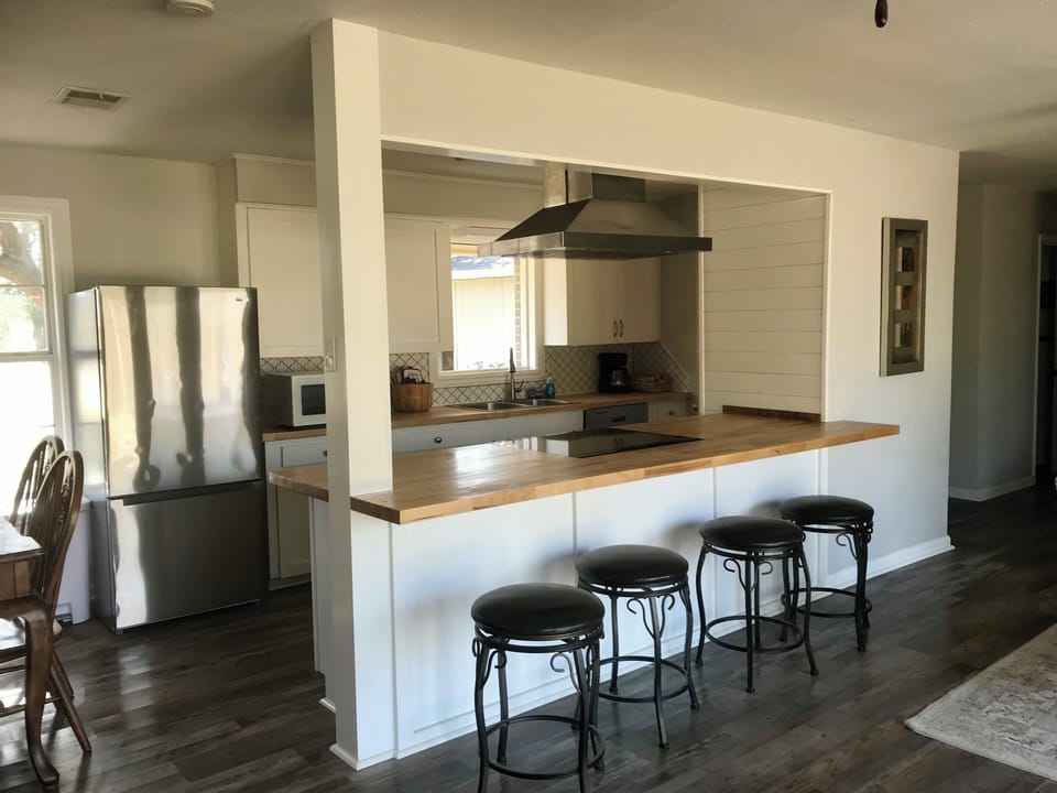Kitchen, dining and snack bar with view of bayou. 