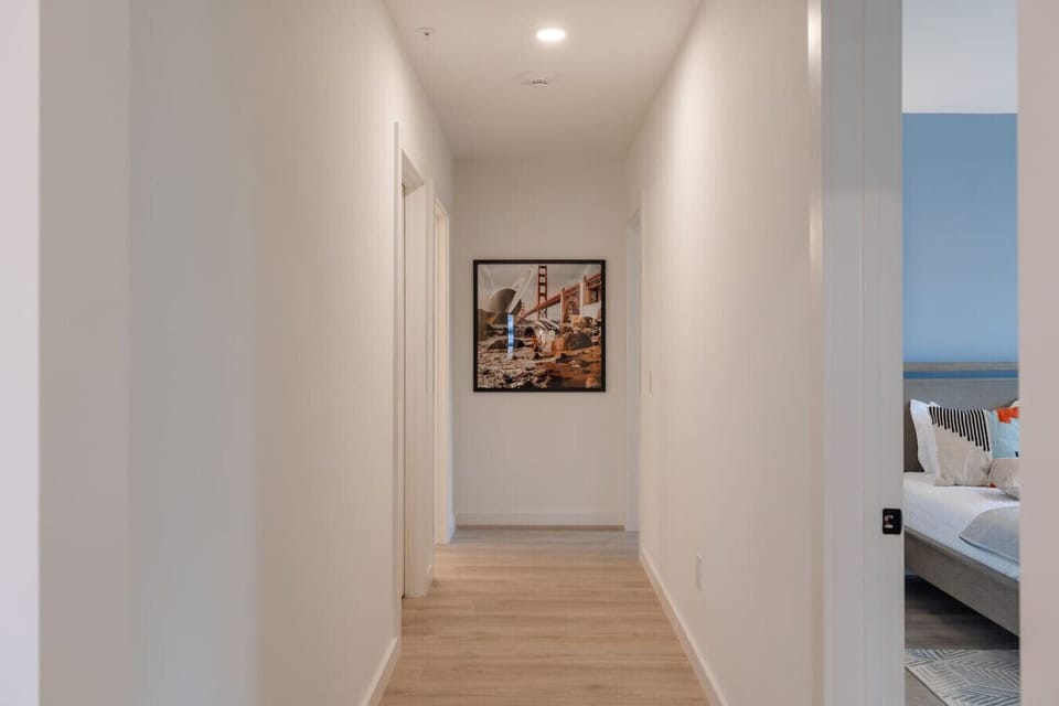 Bright and airy hallway with modern artwork and clean, minimalist design, creating a welcoming transition to the living spaces.