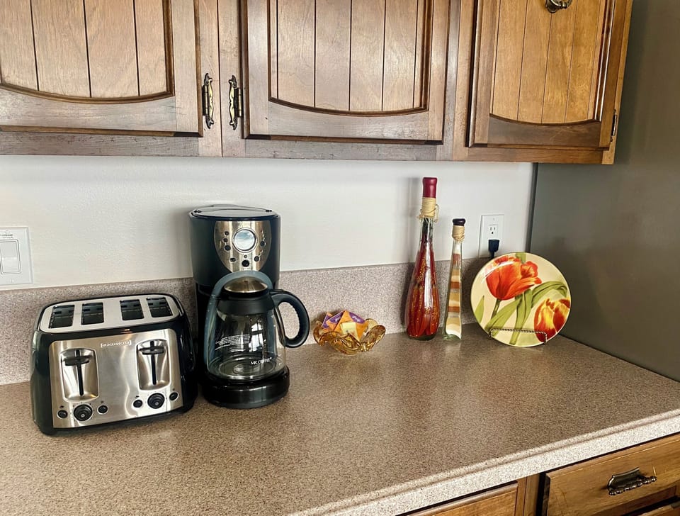 Four slice toaster and a drip coffee maker with filters and teabags provided!