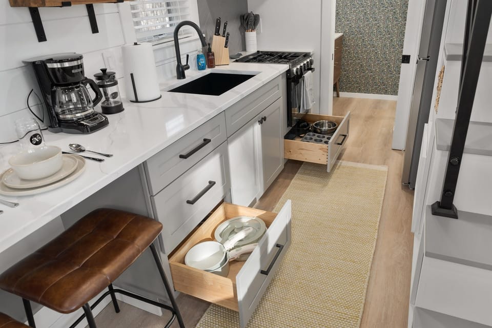 Kitchenette close-up at Whitman — coffee maker, sink, counter space, and pantry basics stocked on arrival