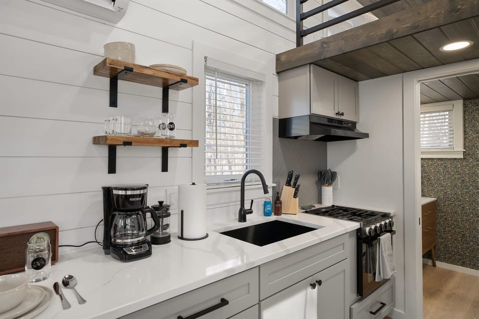 Kitchenette at Whitman — coffee bar, sink, stovetop essentials, and pantry basics stocked on arrival