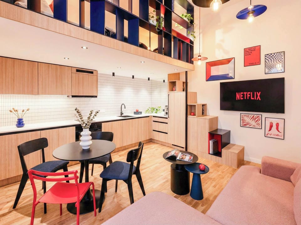 In the living room there is convertible sofa bed, TV with Netflix, kitchen and dinning area