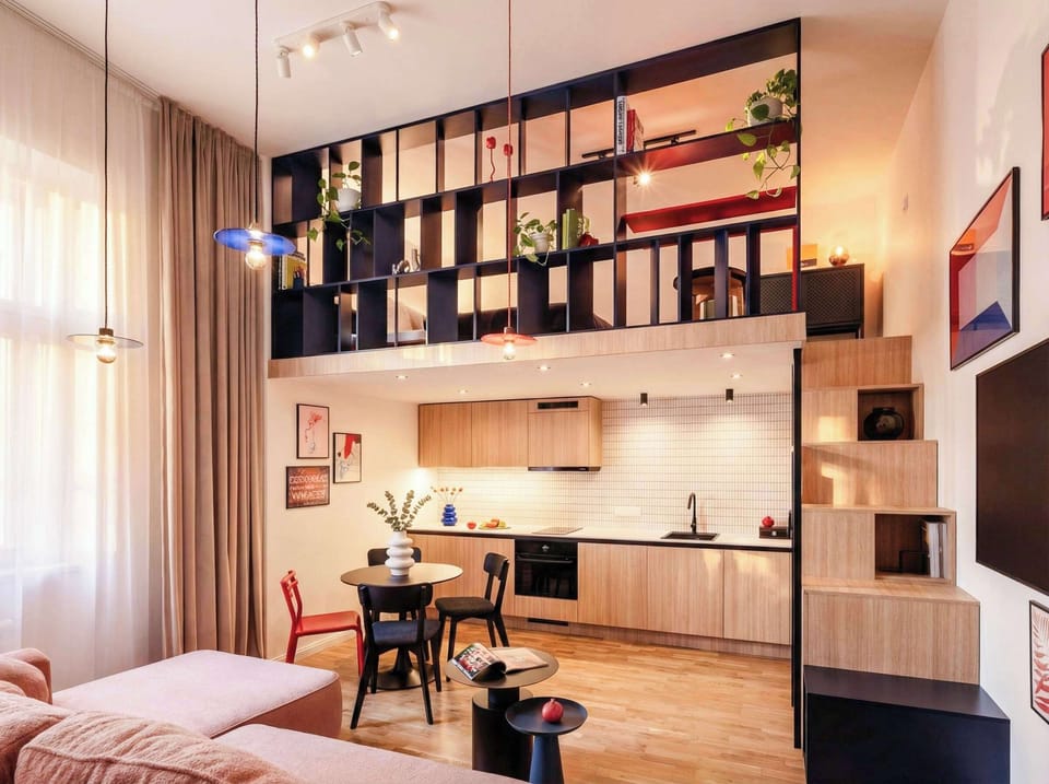 Living room with convertible sofa, kitchen and stairs to the upper bedroom