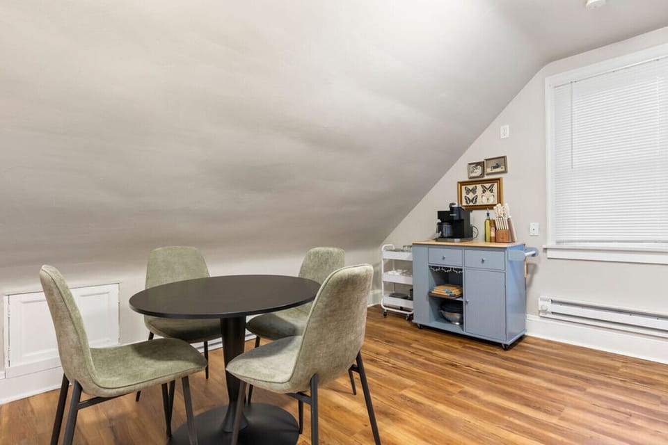 Dining area under sloped ceiling, ideal for memorable gatherings.