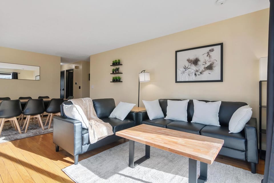 Cozy living area with comfortable seating and a 65" smart Roku TV.