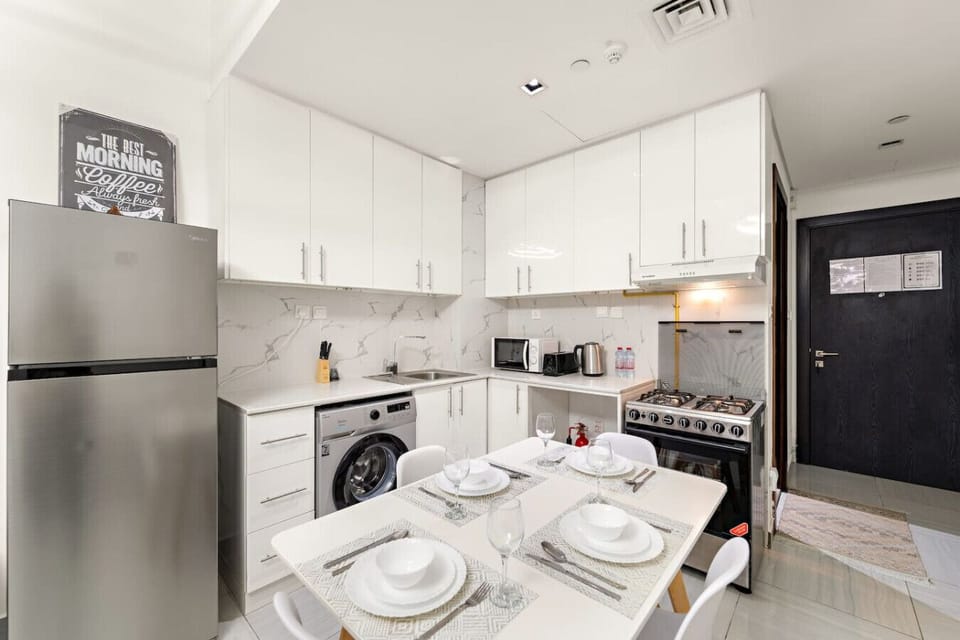 Kitchen: Bright, modern cooking space with sleek appliances and inviting dining setup!