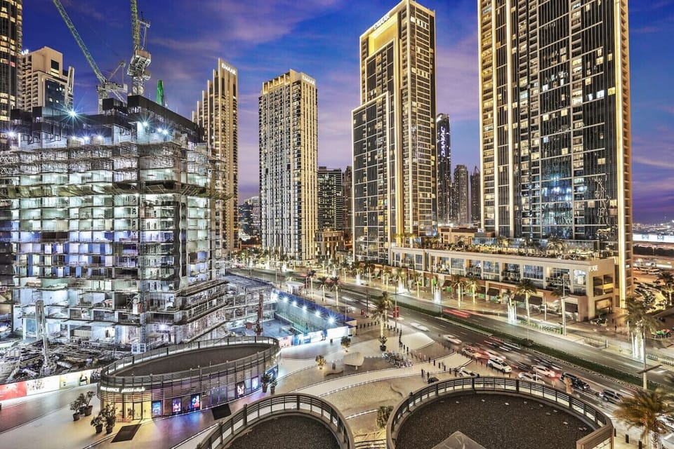 Urban energy: stunning skyscrapers and bustling streets under a purple sky.