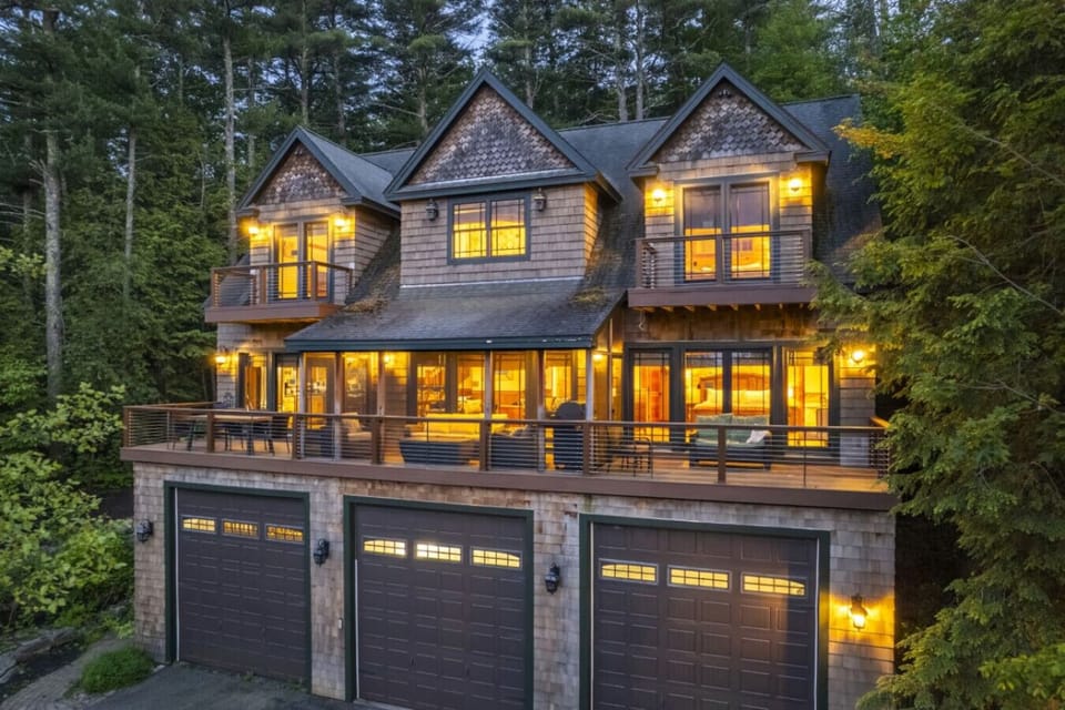 Spacious lakefront retreat with glowing charm, multiple decks, and incredible lake views.