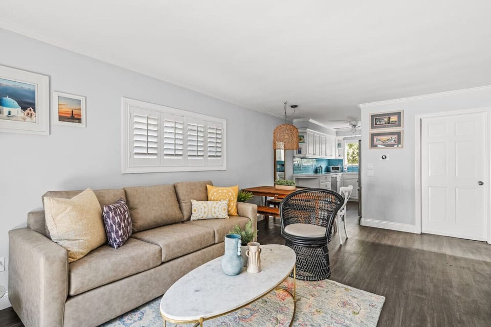 Living room with plenty of seating featuring smart TV with streaming services and easy indoor-outdoor living.