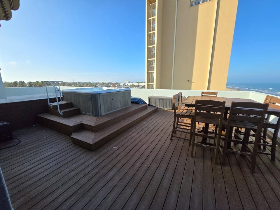 private balcony with hot tub overlooking the beach