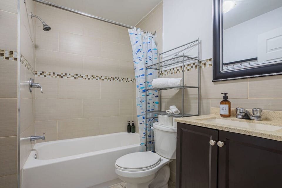 Sparkling clean bathroom with a full tub and modern finishes.