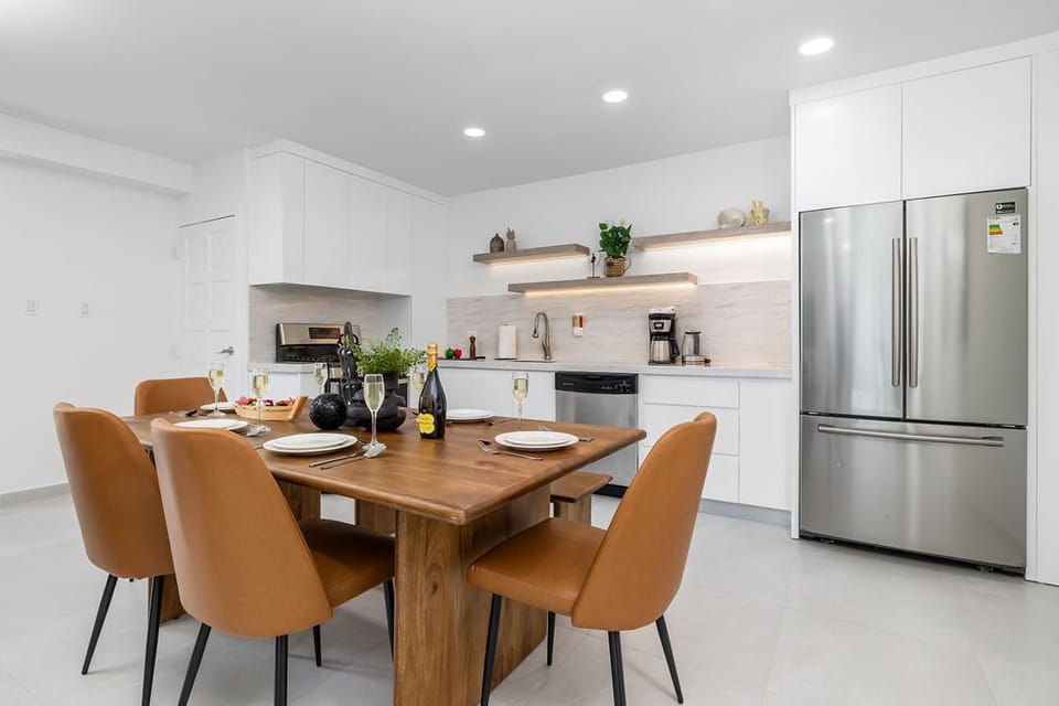 The dining table comfortably seats six, creating a refined yet cozy space for shared meals, lively conversations, and special gatherings.